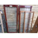 Two pairs of glass panel doors, one in mahogany, the other in teak (A/F two glass panels broken)