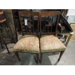 A pair of Edwardian inlaid walnut stickback chairs with pad seat on tapering supports