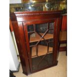 A Victorian style wall hanging mahogany corner cabinet with glazed panel doors