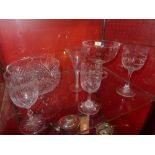 A collection of glassware including a pedestal bowl, punch bowl, engraved glasses, a Commemorative