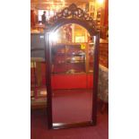 A French style carved walnut cheval mirror with ornate pierced surmount within turned frame on