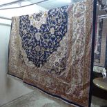 A Persian Kashan style carpet the navy field having foliate medallion and extending floral motif