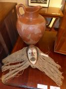 An African carved and painted tribal mask (height 30cm) and a pottery oversized ewer with scroll