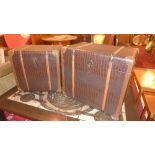 A pair of contemporary designer steamer trunks clad in snakeskin style leather with wooden