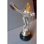 A silvered metal model Spirit of Ecstasy on a slate marble base