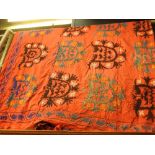 A large late C19th Uzbekistan Sozani wall hanging, red ground with repeating turquoise, black and
