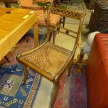 A set of five regency fruitwood bar back dining chairs with cane seats on sabre supports (A/F)