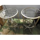 A pair of silvered metal and glass circular occasional tables 71cm (h) (2)