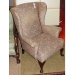 A 20th century Queen Anne style wingback armchair, the geometric upholstery over cabriole front