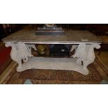 A 20th Century classical design faux marble table, the shaped top raised on griffin supports to