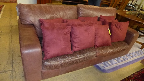 A 20th Century distressed brown leather two seater sofa 210x95x86cm