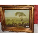 A 20th century landscape print with figures lounging in the foreground in a gilt frame