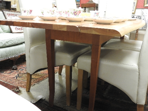 A large cherrywood table with twin flaps raised on tapered supports 76cm x 235cm x 68cm