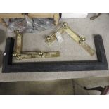 A black cast iron fender and two modern gilt metal hearth corner edges /fire dogs  (3)