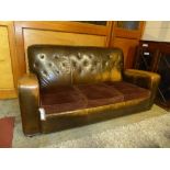 A French 1930s tanned leather club style three seater sofa, with three brown velour upholstered