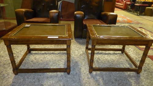 A pair of faux walnut lamp tables having cane and glass inset tops on square tapering supports