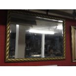 A horizontal bevelled mirror with gilt rope-twist frame