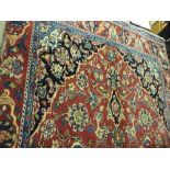 An extremely fine Central Kashan rug, the central sapphire floral medallion on a rouge field with