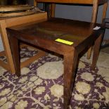 A fruitwood square low table raised on tapered supports 52cm x 60cm