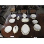 An early 20th Century W H Grindley & Co 53 piece dinner service in white and gold decoration.