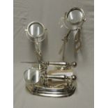 A pair of chrome magnifying glasses on adjustable stands, along with another and a letter opener