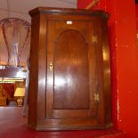 A Georgian oak corner cupboard fitted si
