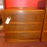 An oak three drawer chest and a matching