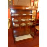 A 20th century rosewood open bookcase wi