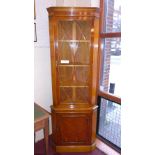 A yew wood and oak corner cabinet fitted