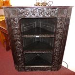 A Victorian profusely carved corner cabi