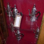 A set of six silver plated coffee pots with black handles.