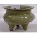 A Chinese celadon incense burner raised on three supports.