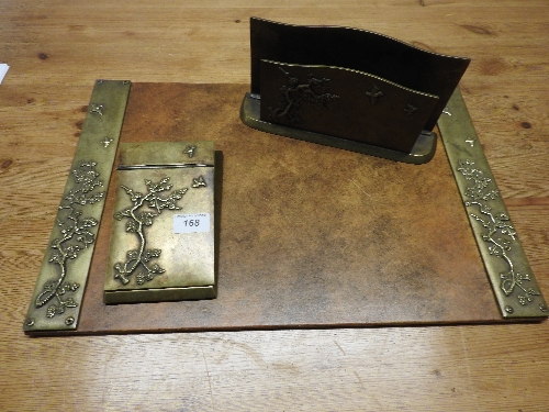 An Art Deco brass desk set including writing pad, note pad and letter pack,