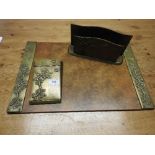 An Art Deco brass desk set including writing pad, note pad and letter pack,