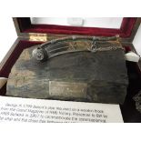 A George III silver bosun's pipe, mounted on a wooden block from the Grand Magazine of HMS Victory,