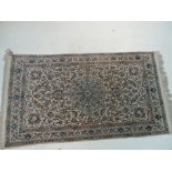 A hand made Persian woollen and part silk Esfehan rug the foliate design within matching border on a