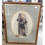 An early 20th century oval portrait of a Sailor's boy in period oak frame
