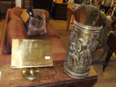 A large brass jug with repousse decoration and a brass table top lectern 63cm x 45cm (2)