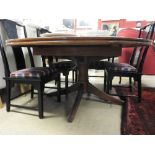 A mahogany crossbanded extending dining table with extra leaf raised on quadruped supports.