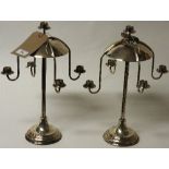 A pair of modern candelabra, each with four scroll arms on circular weighted base, by R. G.