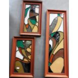 A collection of four framed stained glass window fragments