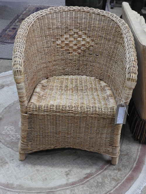 A modern wicker tub form conservatory chair