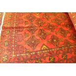 A fine North East Persian Turkoman rug, with diamond and geometric motifs on a rouge field,