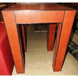 A contemporary design red leather occasional table,