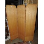 An Art Deco design oak three fold screen of panelled construction