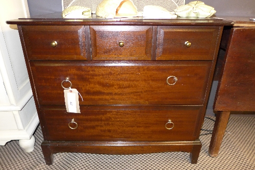 A 20th century stag mahogany chest of three short over two long drawers on long bracket supports W