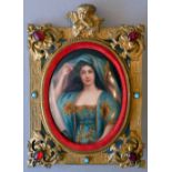 An extremely fine oil on ceramic oval portrait of a lady in a turquoise and gold dress, 11cm x 9cm,
