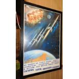 A Russian poster framed, celebrating the space race.