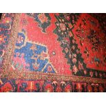 A handmade Persian Ferdos carpet,