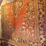 A fine North West Persian Belouch rug with central pendant floral medallion and four corner floral